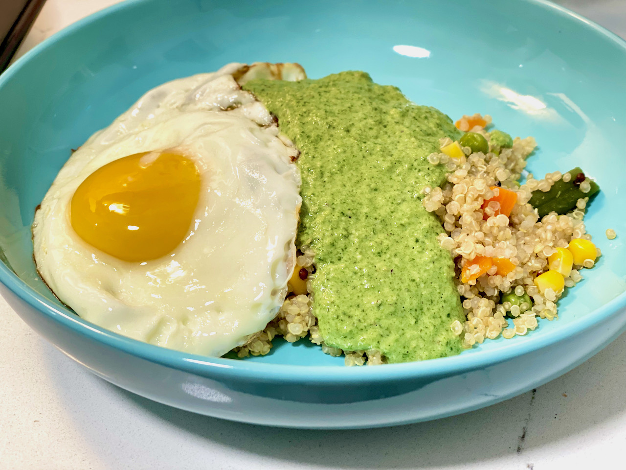 peruvian pesto quinoa bowl with fried egg