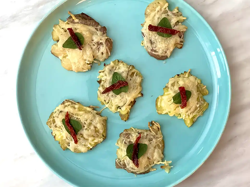 air fryer parmesan crusted potatoes with oregano and tomato